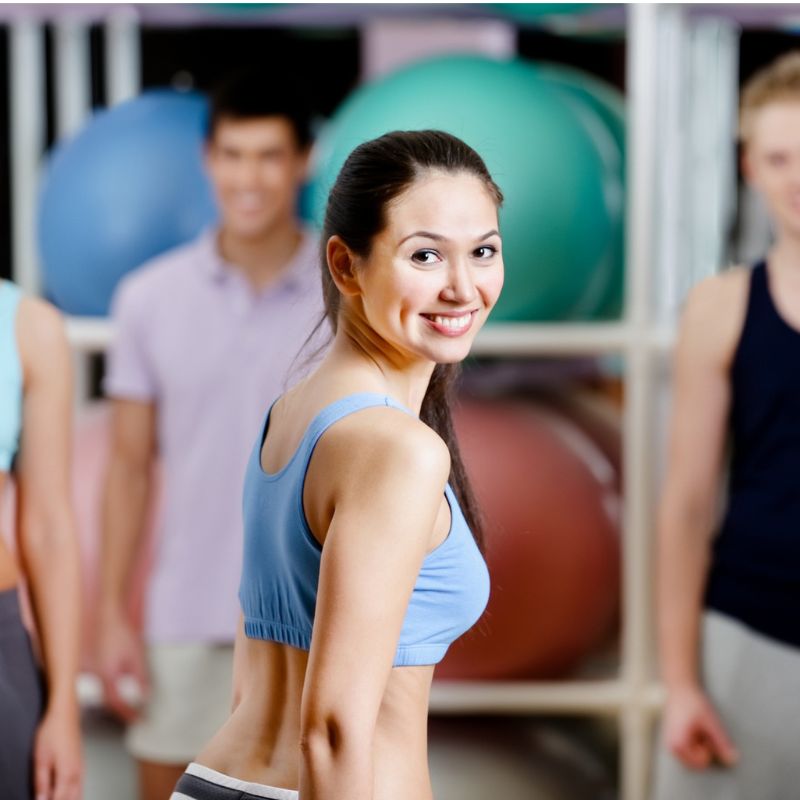 Group of active people in sportswear at the gym in a aerobics class
